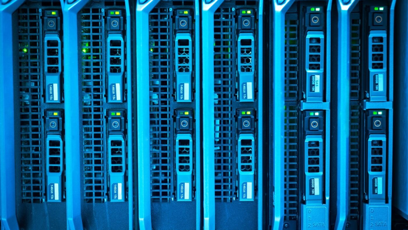 Rows of illuminated blue server racks in a data center