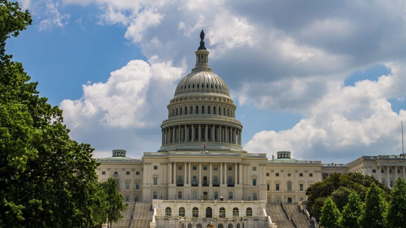 Exterior of a large government office building under cloudy sky