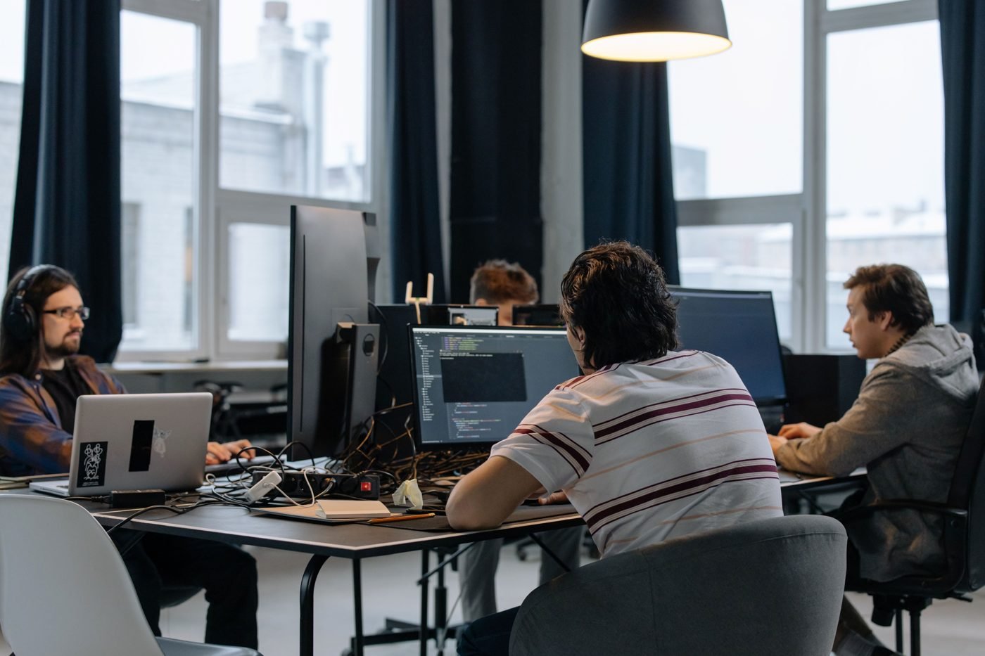 Software developers working at computers in a shared office
