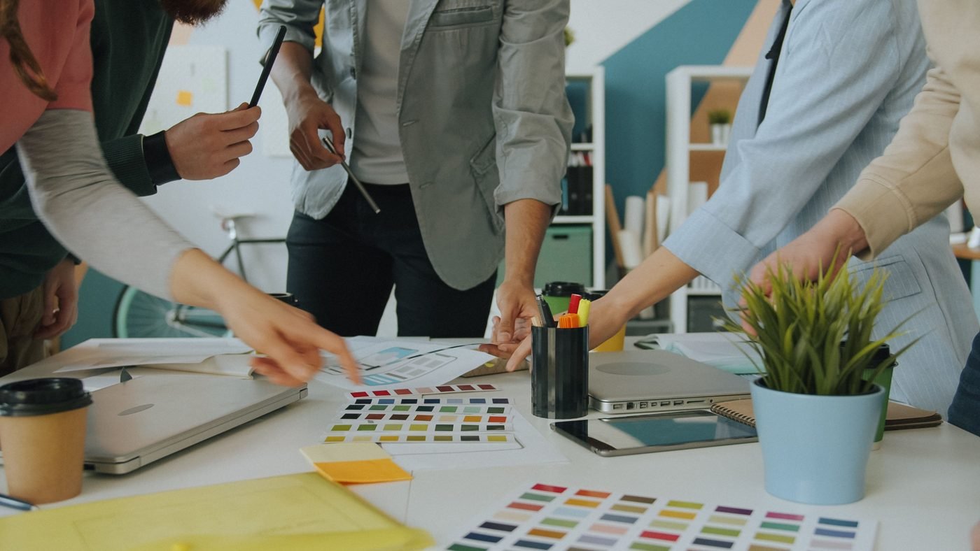 Design team comparing color swatches around a table