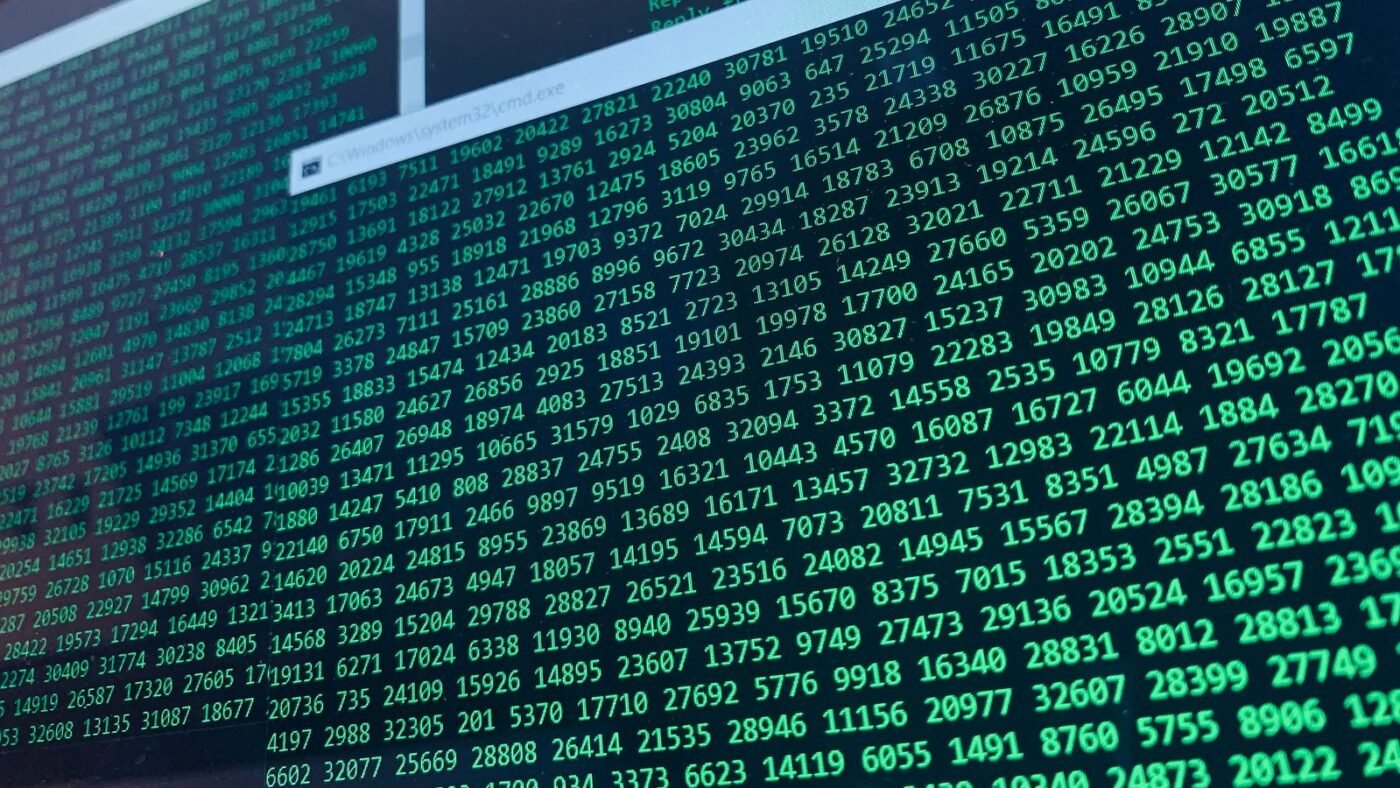 Green lines of code and data streams on a computer screen