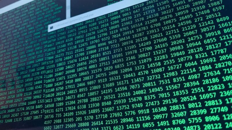 Green lines of code and data streams on a computer screen