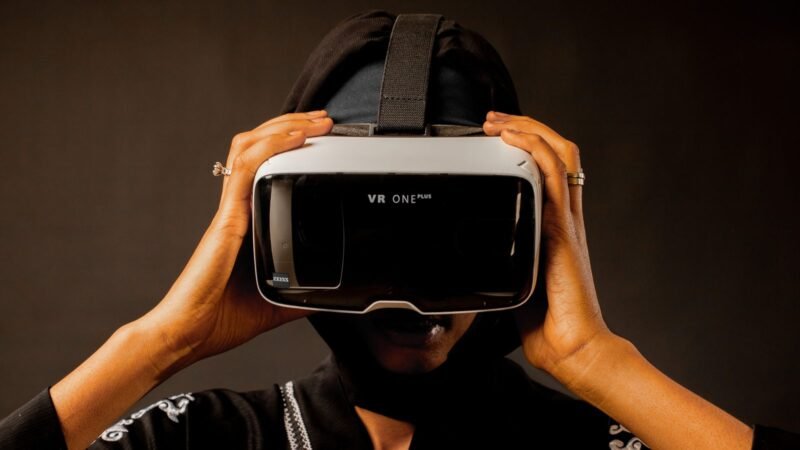 Person wearing a virtual reality headset in a dark room