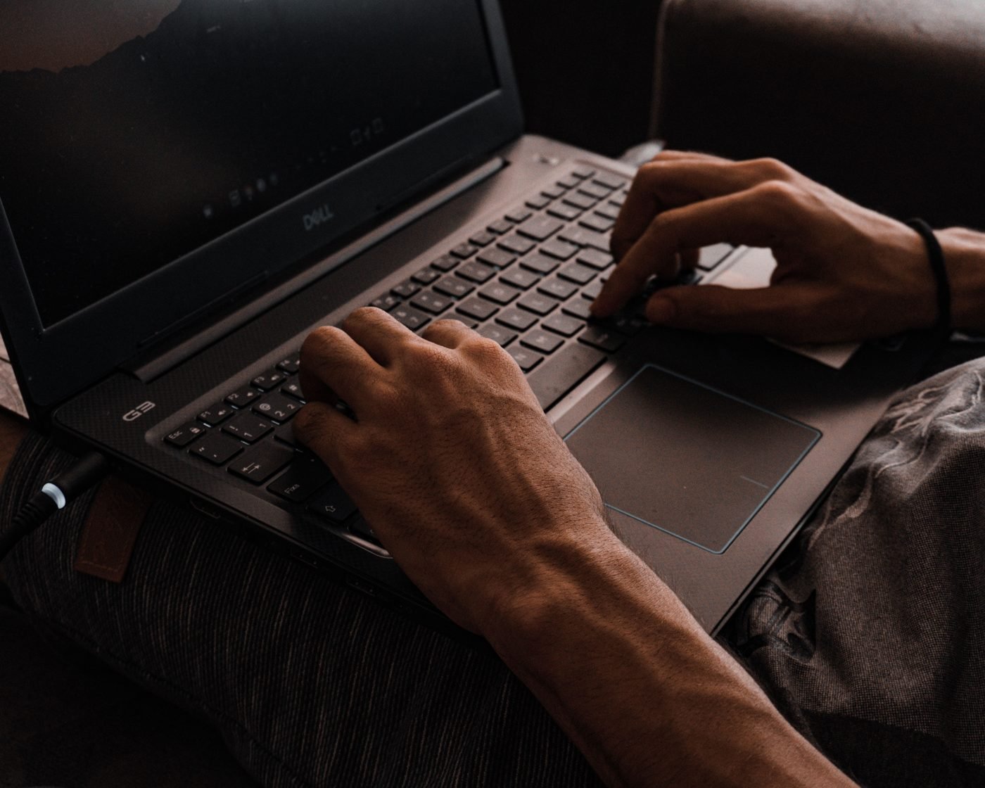 Close-up of hands typing on a laptop keyboard