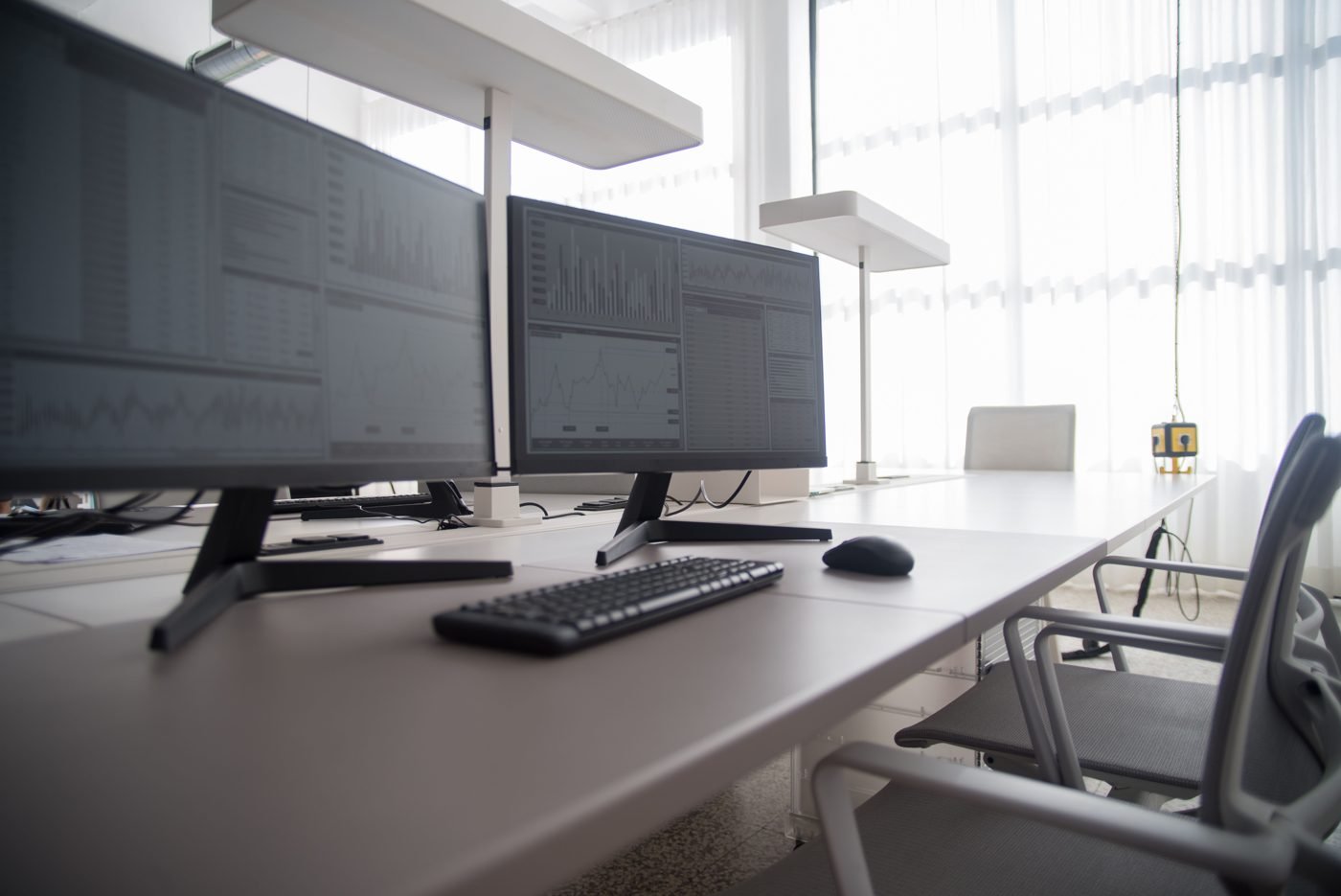 Modern office with multiple computer monitors on desks