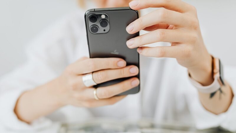 Woman holding an iPhone with both hands