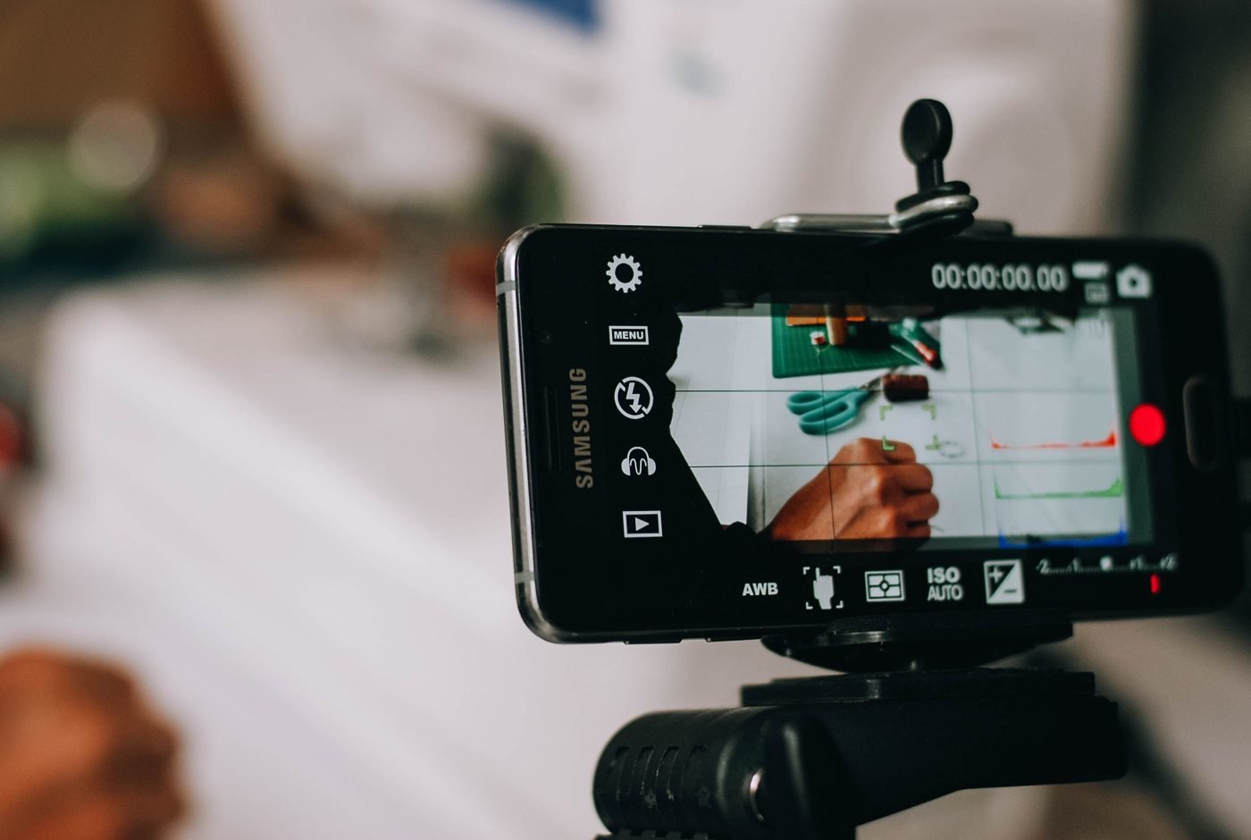 Smartphone mounted on a small tripod recording video
