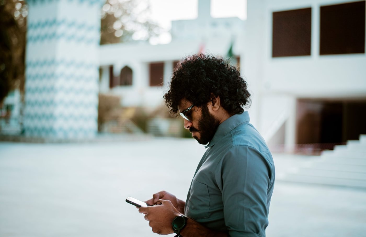 Man checking his smartphone outdoors