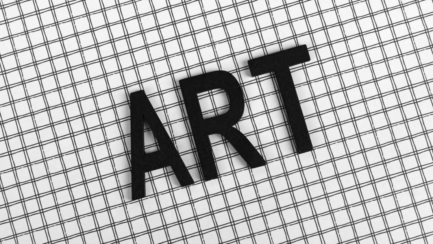 Black letters spelling ART on a black and white grid