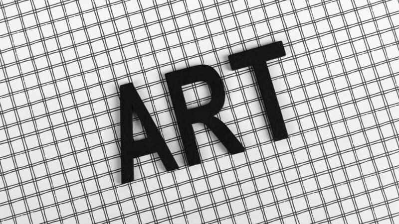 Black letters spelling ART on a black and white grid