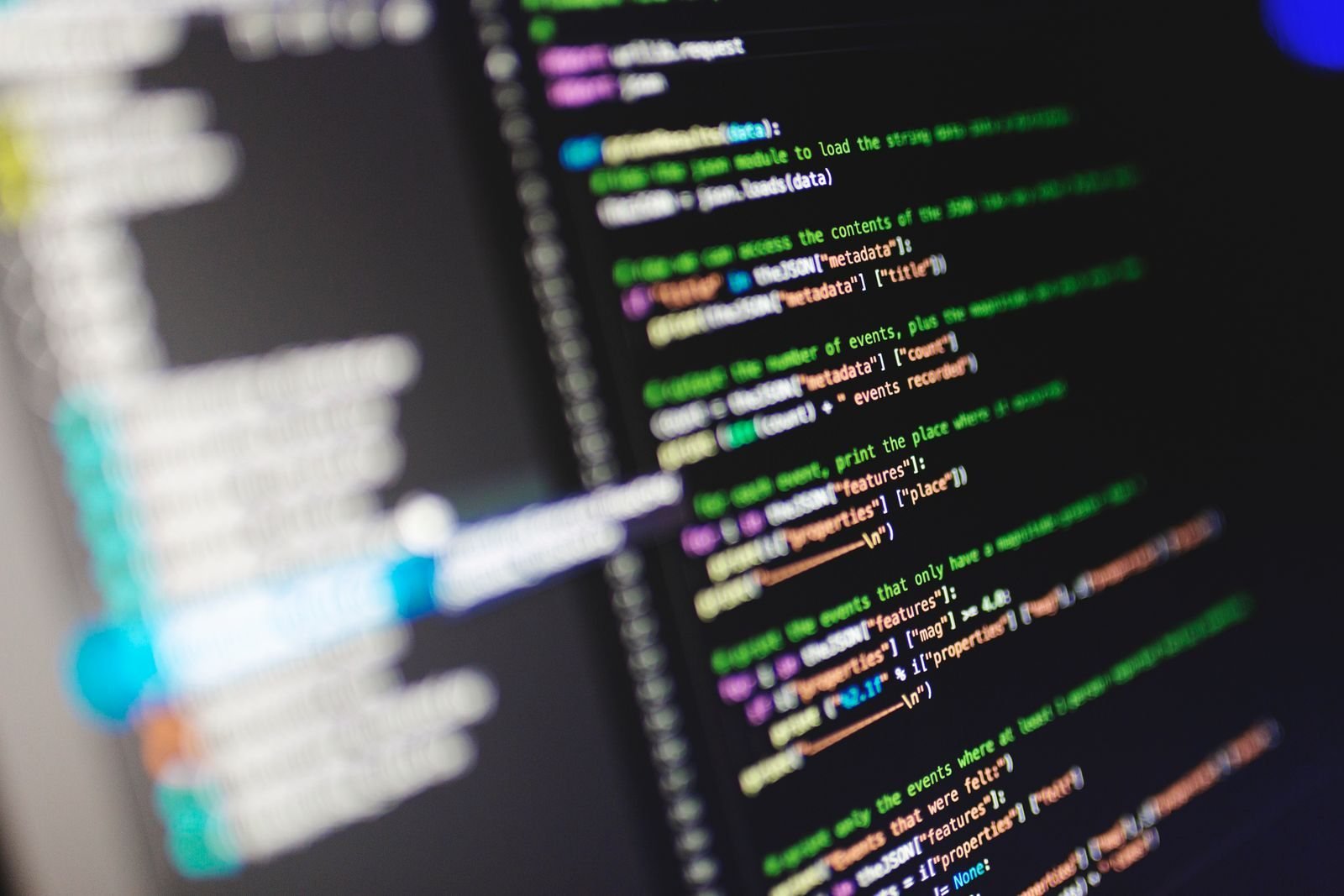 Lines of colorful source code on a computer monitor, representing AI coding agents