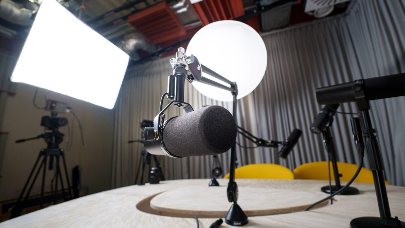 Podcast recording studio with microphones, chairs and lighting