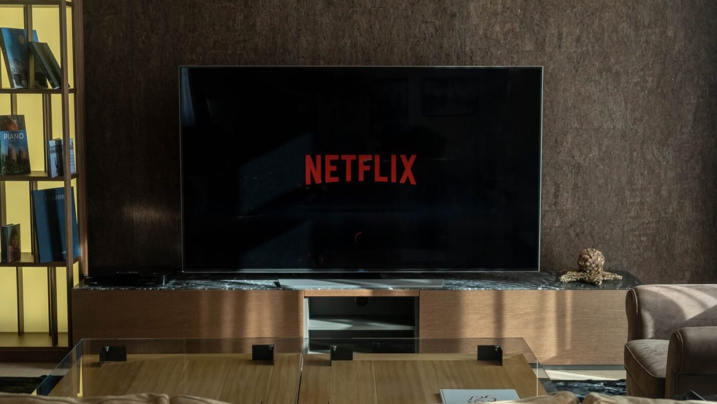 Netflix logo on a large TV screen in a dimly lit living room