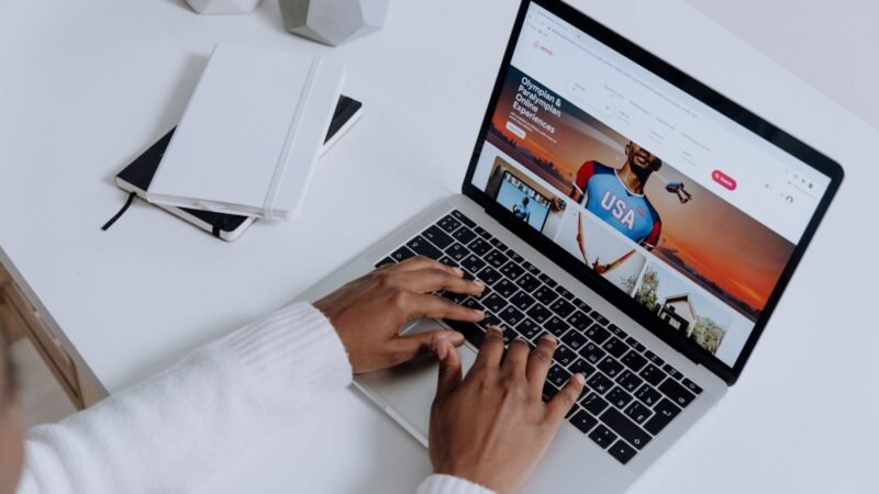 Person typing on a laptop showing a web browser