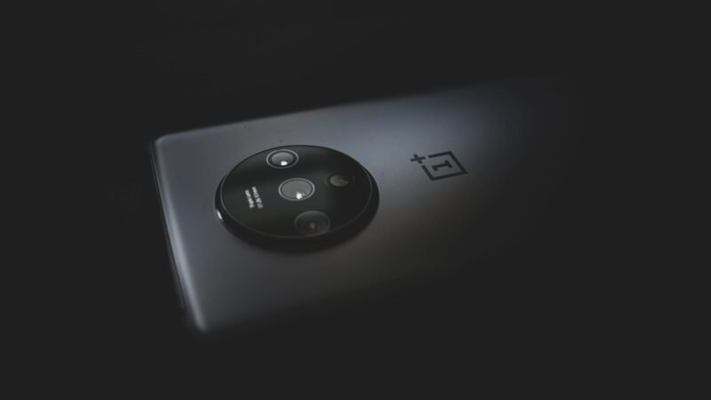 Close-up of a modern smartphone camera module against a dark background