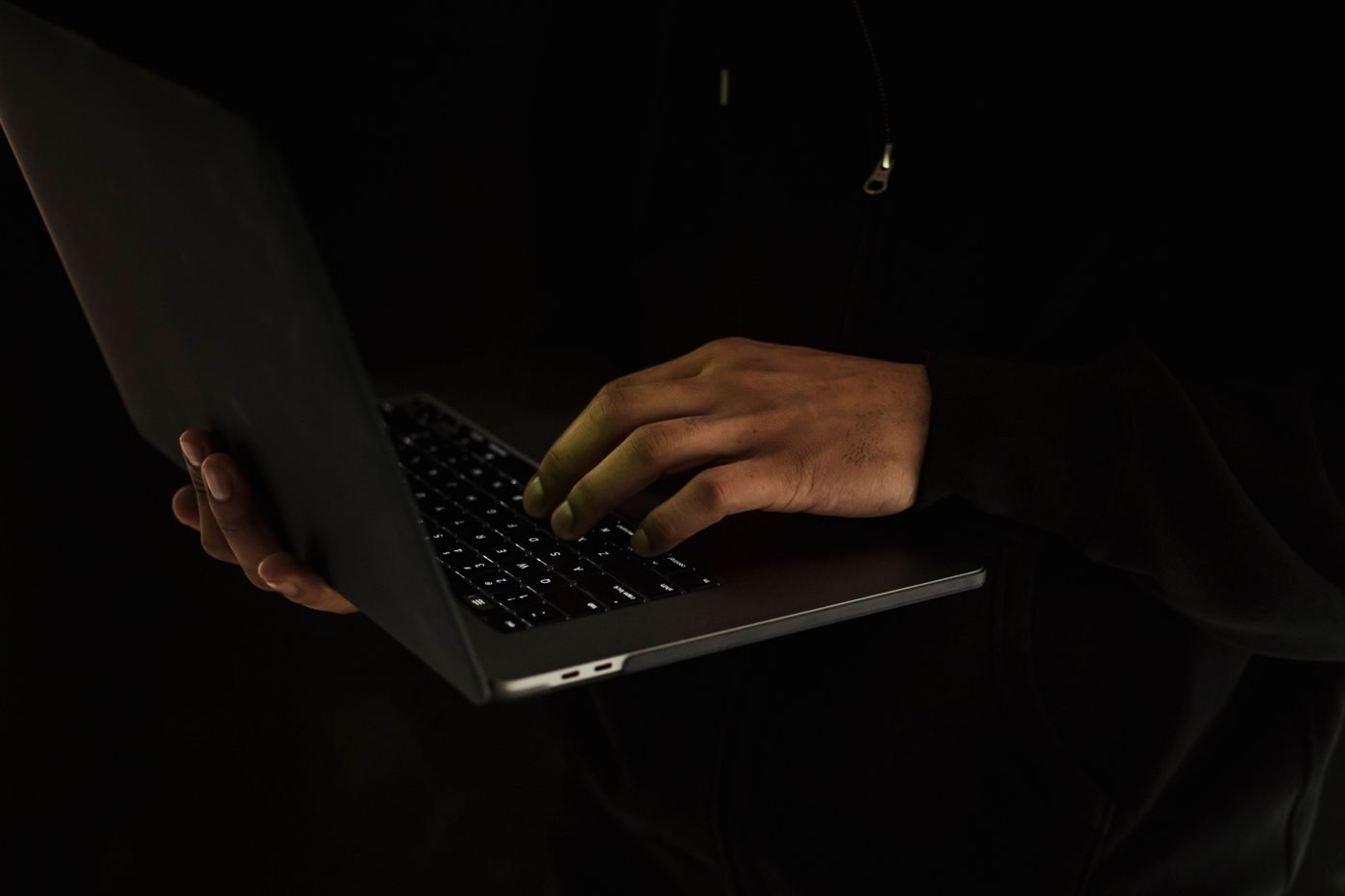 Person working on a laptop at a desk, seen from above