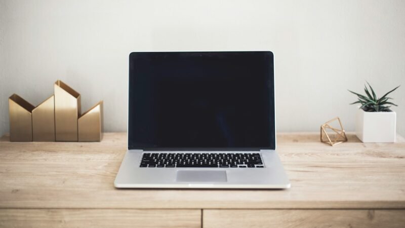 Modern laptop computer on a minimalist desk, representing a tech product launch