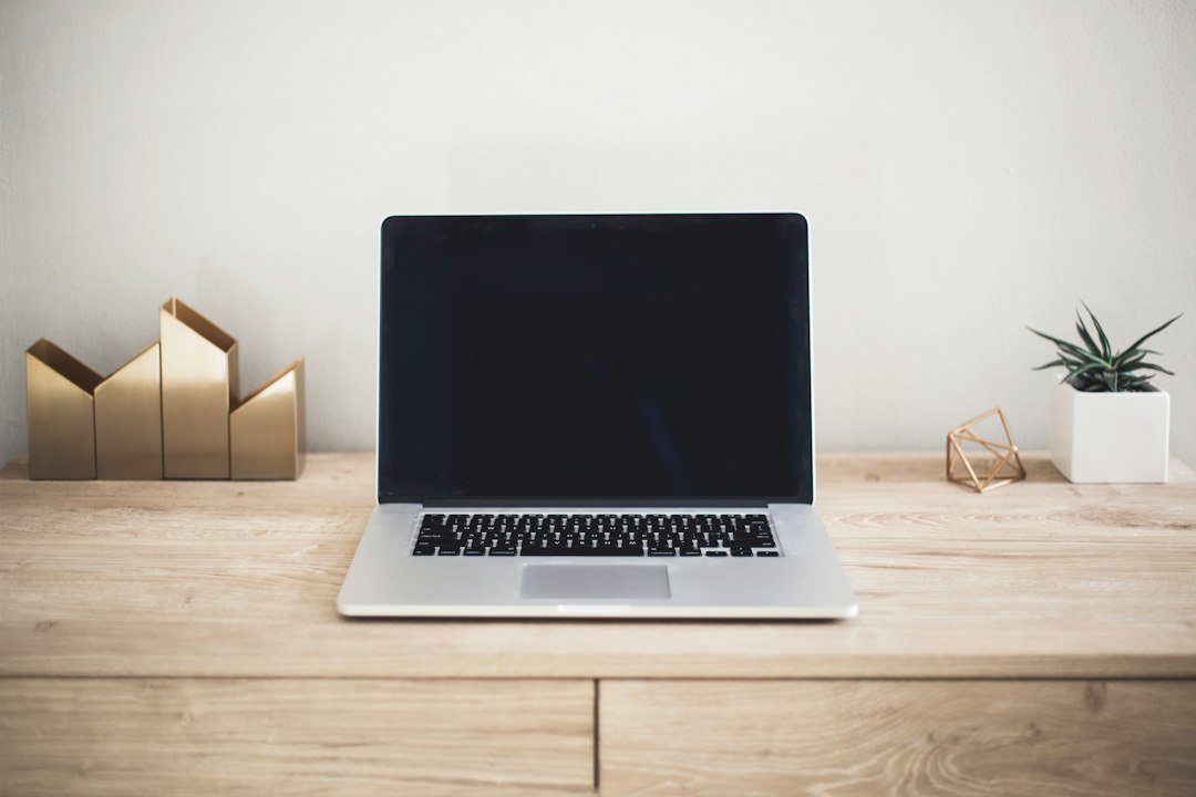 Modern laptop computer on a minimalist desk, representing a tech product launch