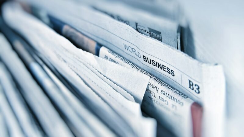Stack of business newspaper pages