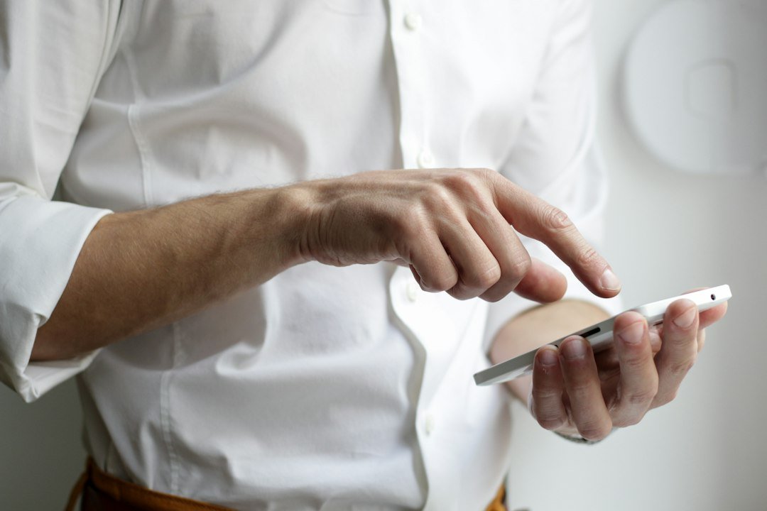 Close up of hands typing a message on a smartphone messaging app