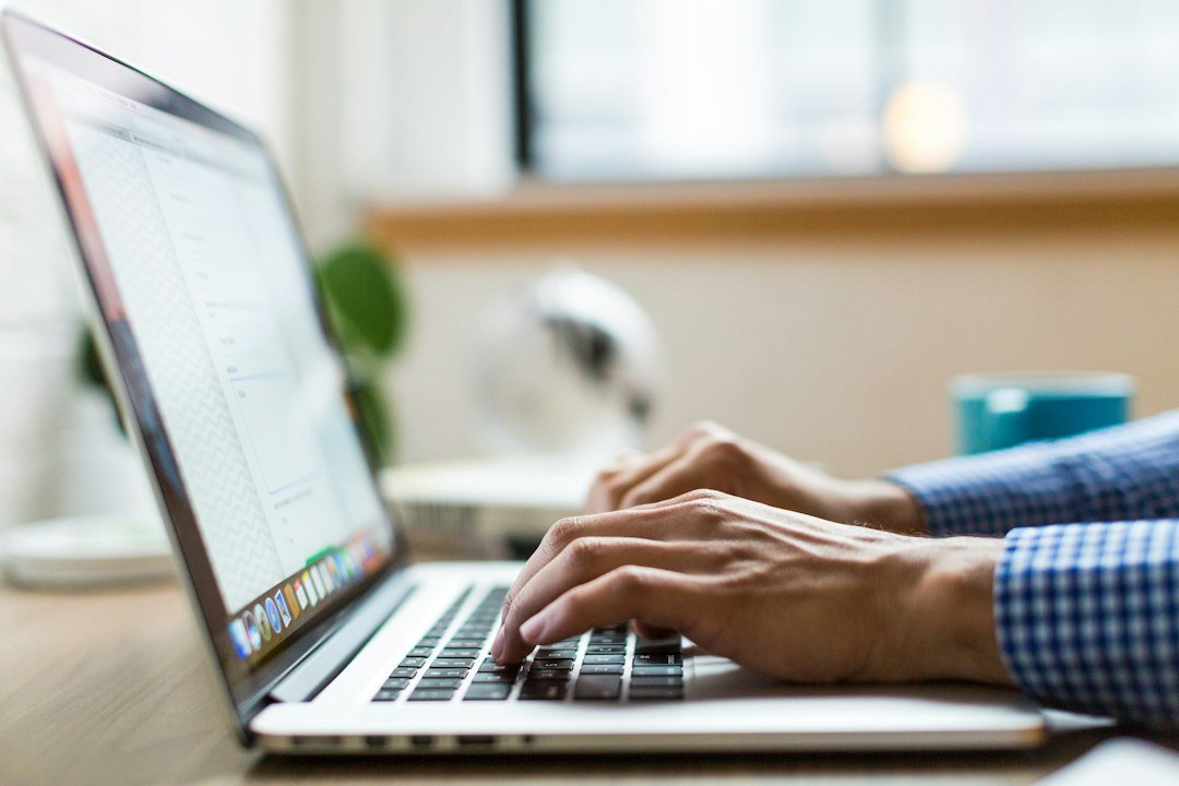 Microsoft's next event is about files, not hardware Person typing on a silver laptop