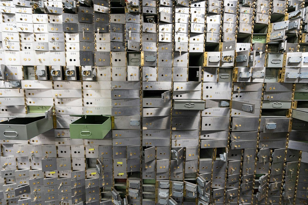 Empty bank vault safe deposit boxes representing a financial sector data breach