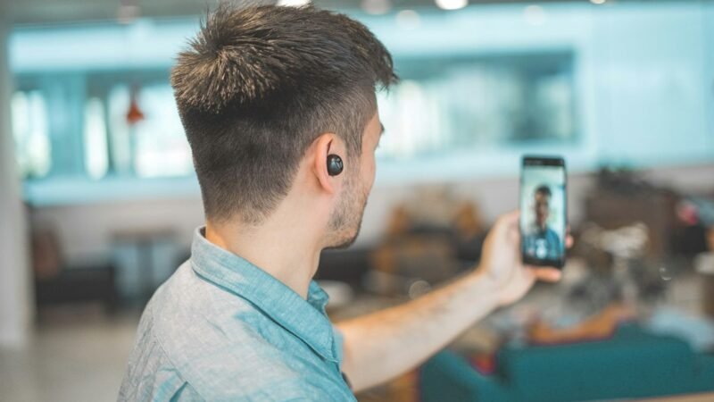 Person using a smartphone for a video call, illustrating WhatsApp's new guest calling feature