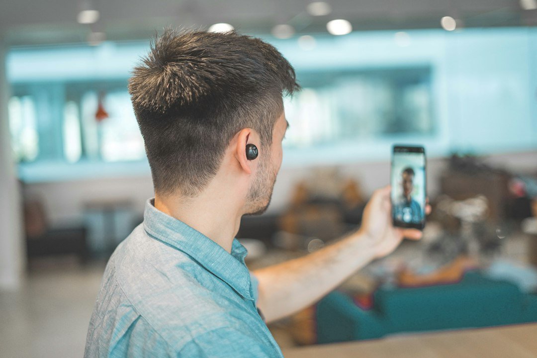 Person using a smartphone for a video call, illustrating WhatsApp's new guest calling feature