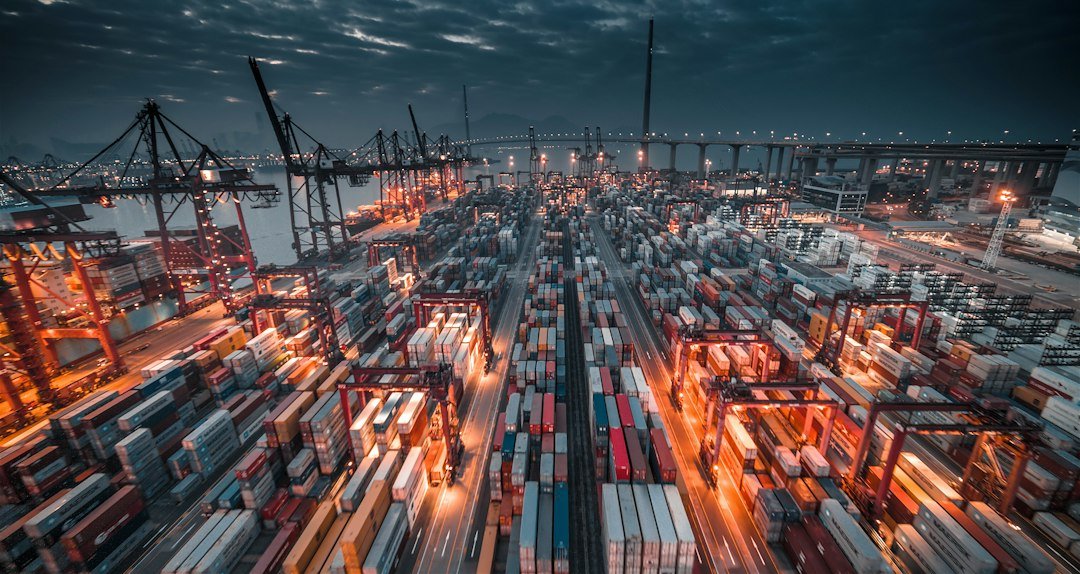 Stacked shipping containers representing cross-border technology trade controls