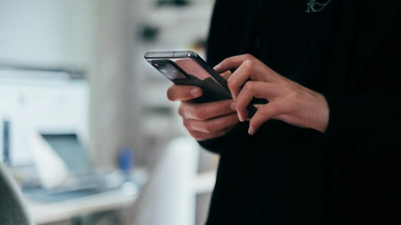 Person holding a smartphone, representing a new AI texting assistant app