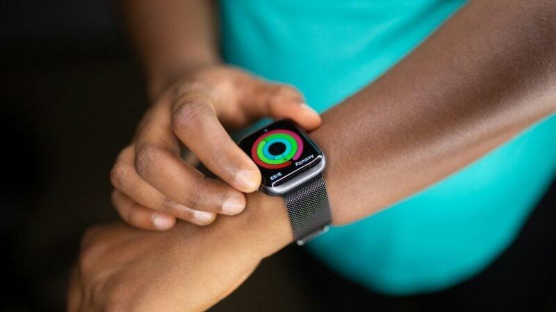 Woman checking a smartwatch on her wrist, representing a wearable AI assistant