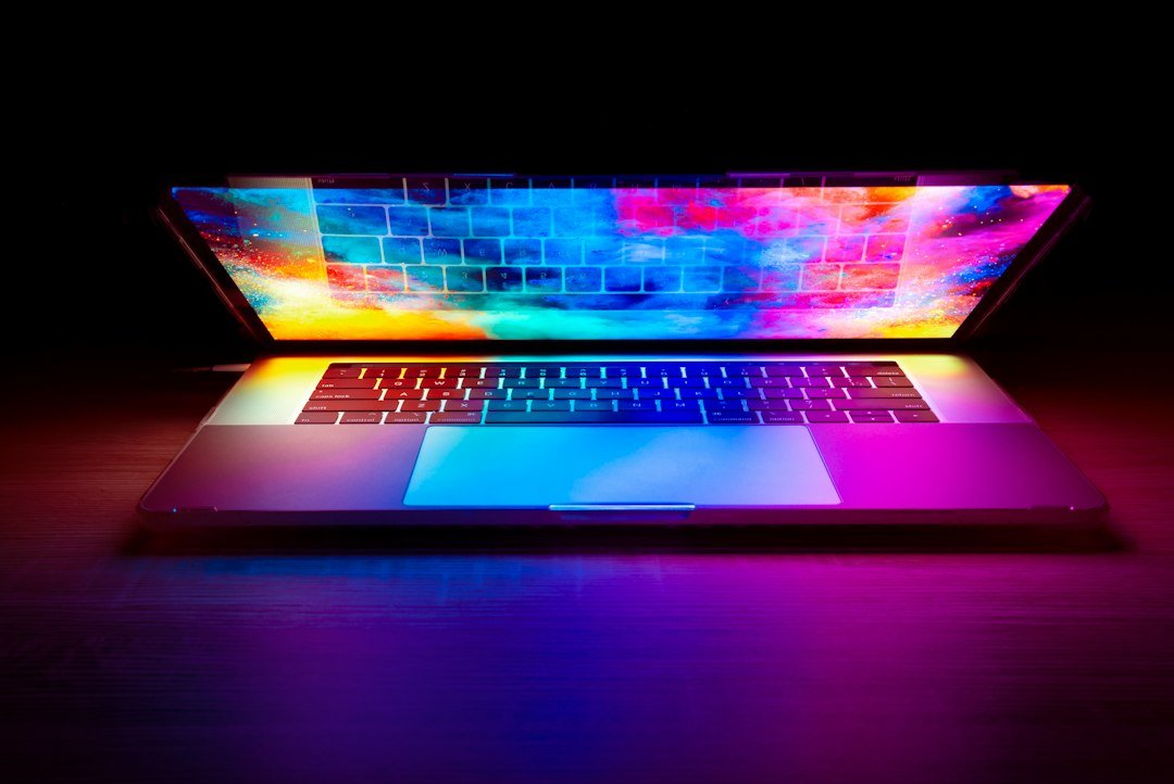 Colorful light burst over a laptop notebook computer representing new hardware