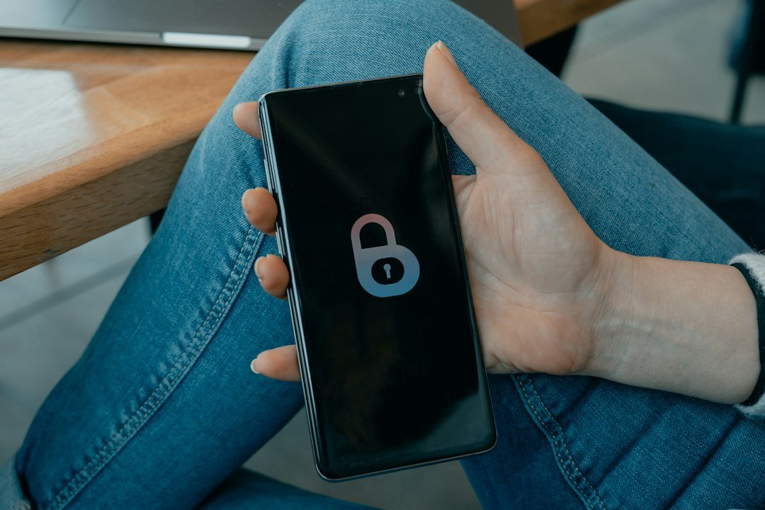 Hand holding a smartphone displaying an app on the lock screen