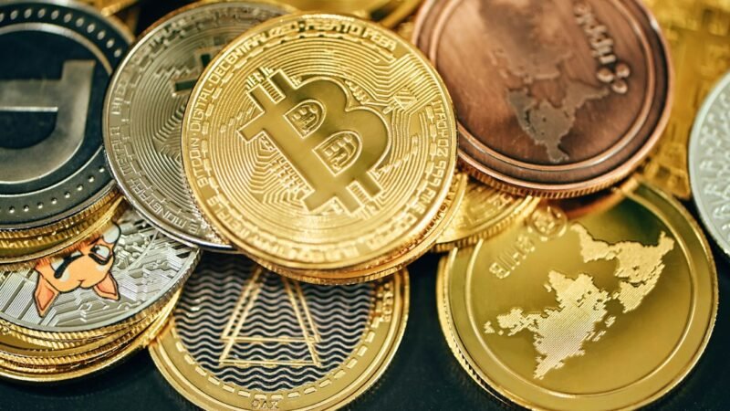 Pile of cryptocurrency coins on a dark background