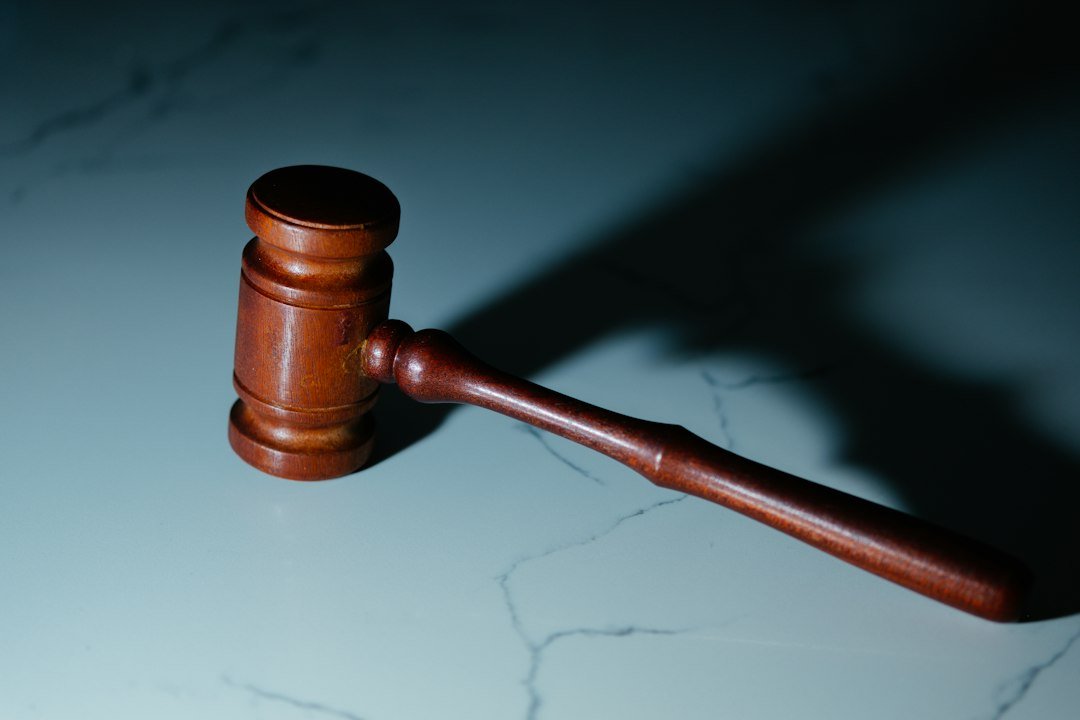 Wooden judge's gavel resting on a table in a courtroom