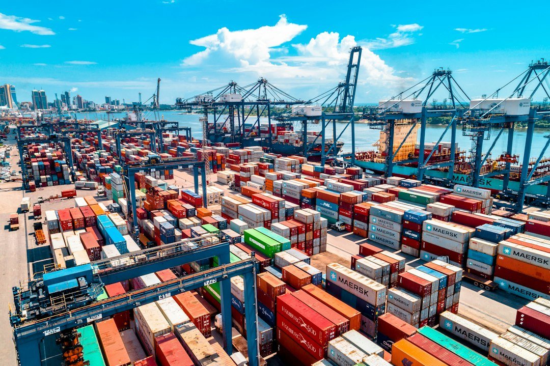 Port harbor with cargo cranes representing global technology export routes