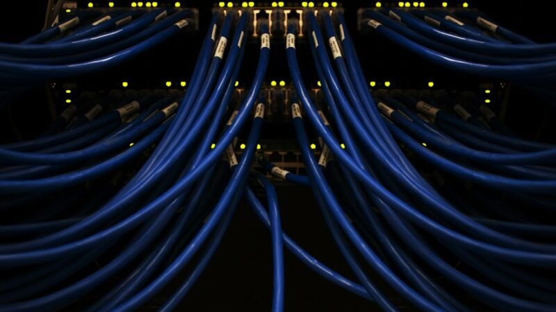 Blue networking cables representing photonic interconnects inside an AI data center