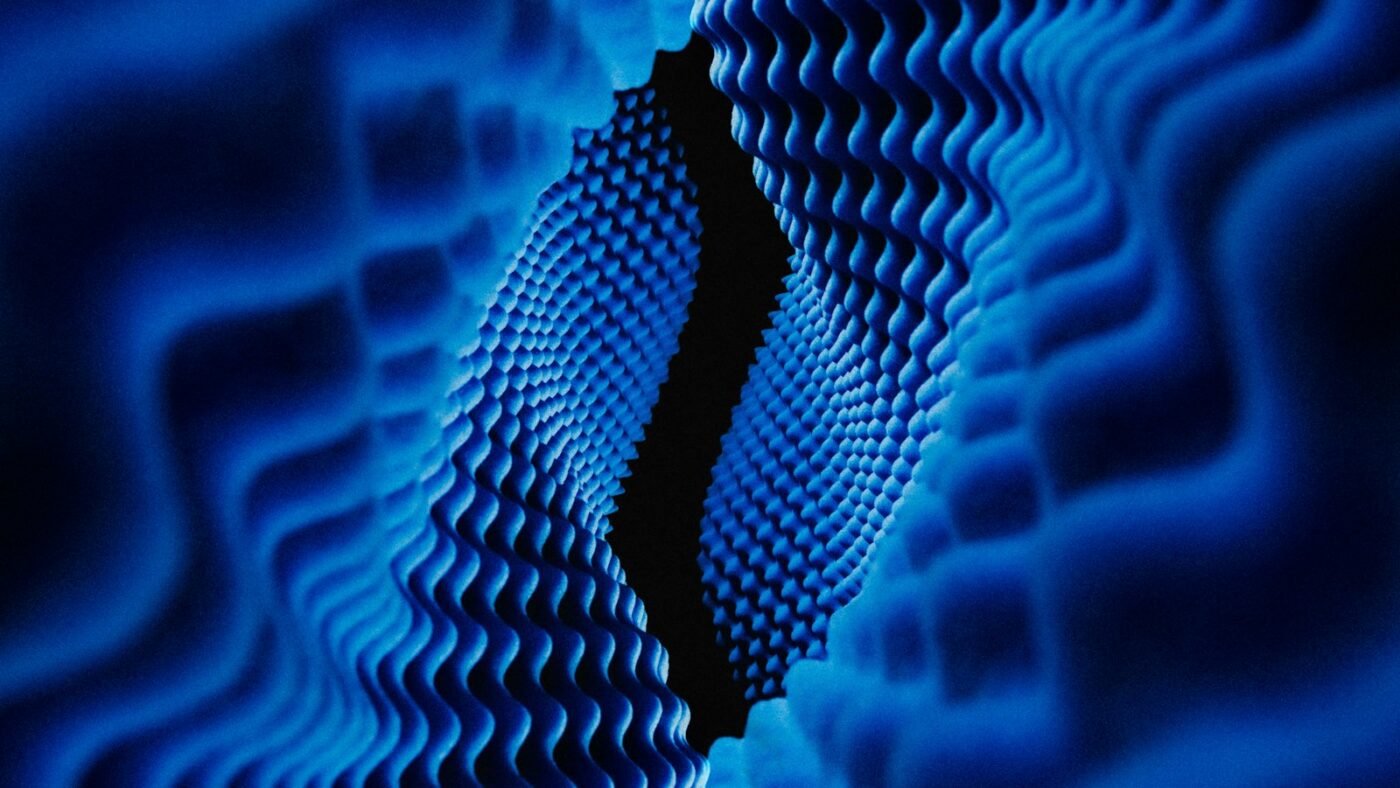 Close-up of a quantum computing chip illuminated with blue light