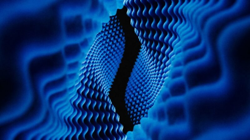 Close-up of a quantum computing chip illuminated with blue light
