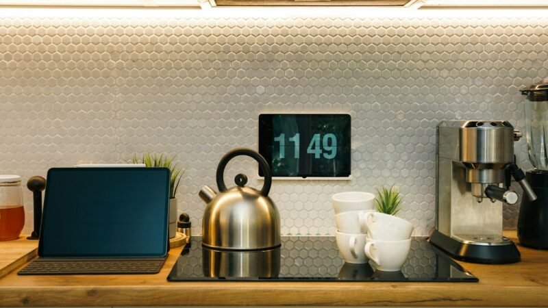 Modern kitchen counter with a digital clock display and coffee maker