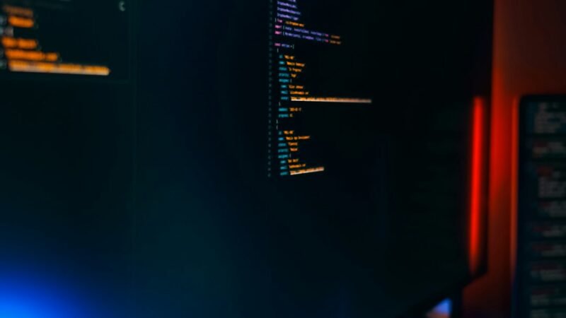 Dark workspace with monitors showing code, representing exposed AI agent session logs