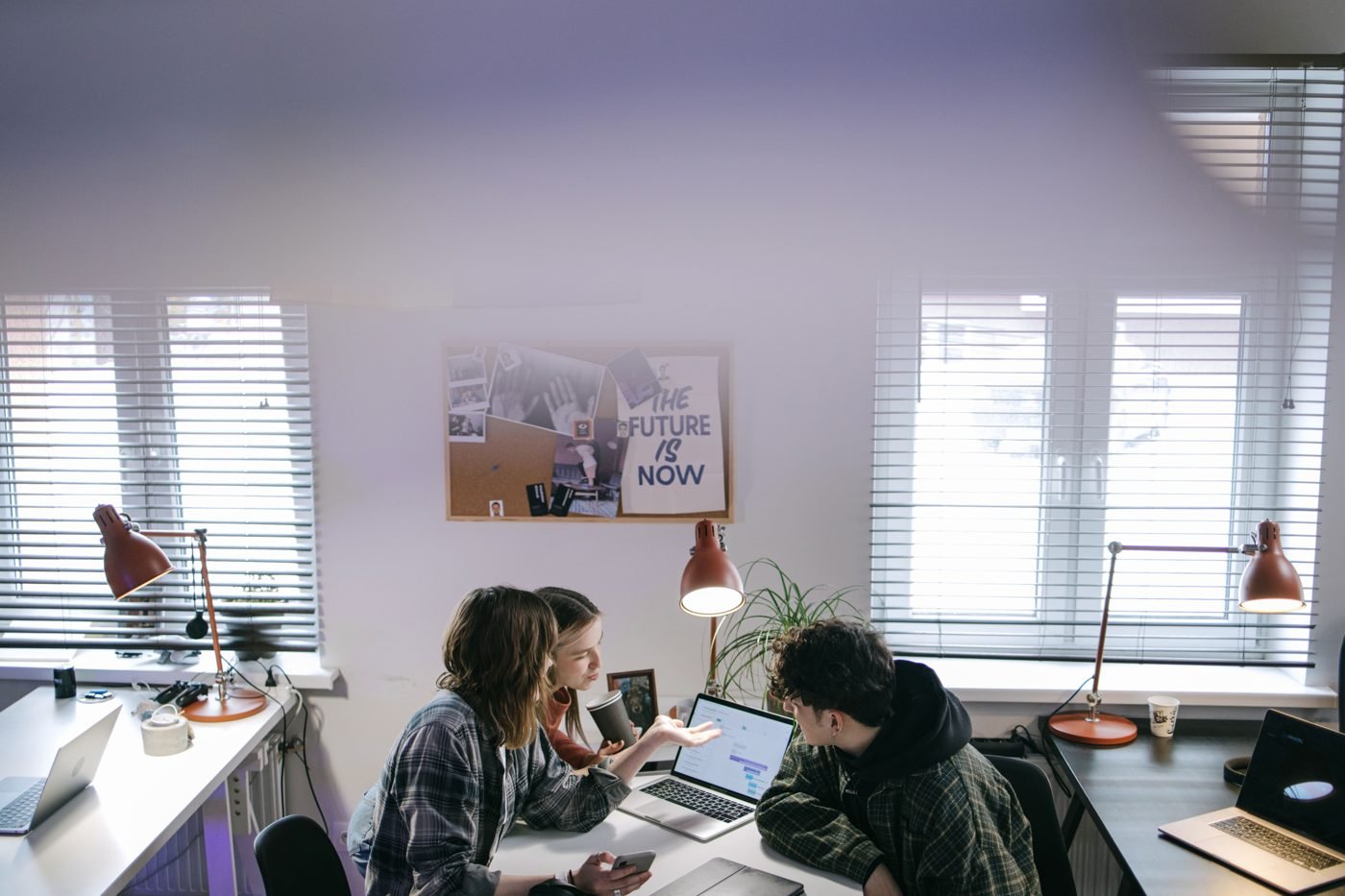 Team collaborating around a whiteboard in a bright office