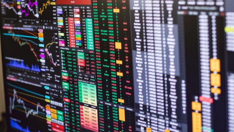Financial trading screen showing colorful market charts and data