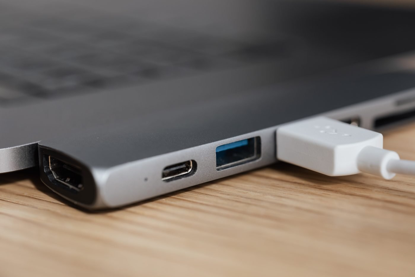 Close-up of a laptop's side ports with a USB cable plugged in