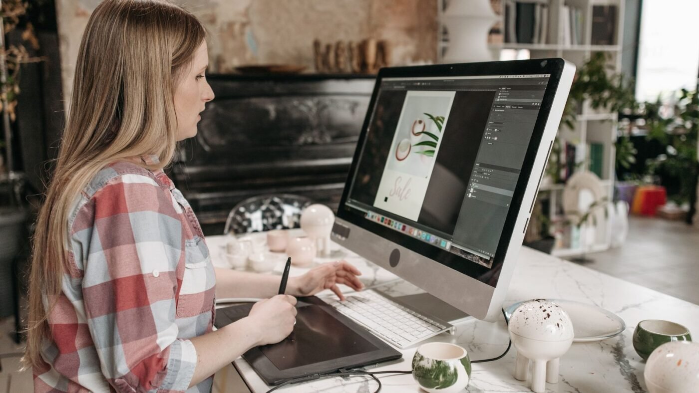 Designer drawing on a digital pen tablet at a desktop computer