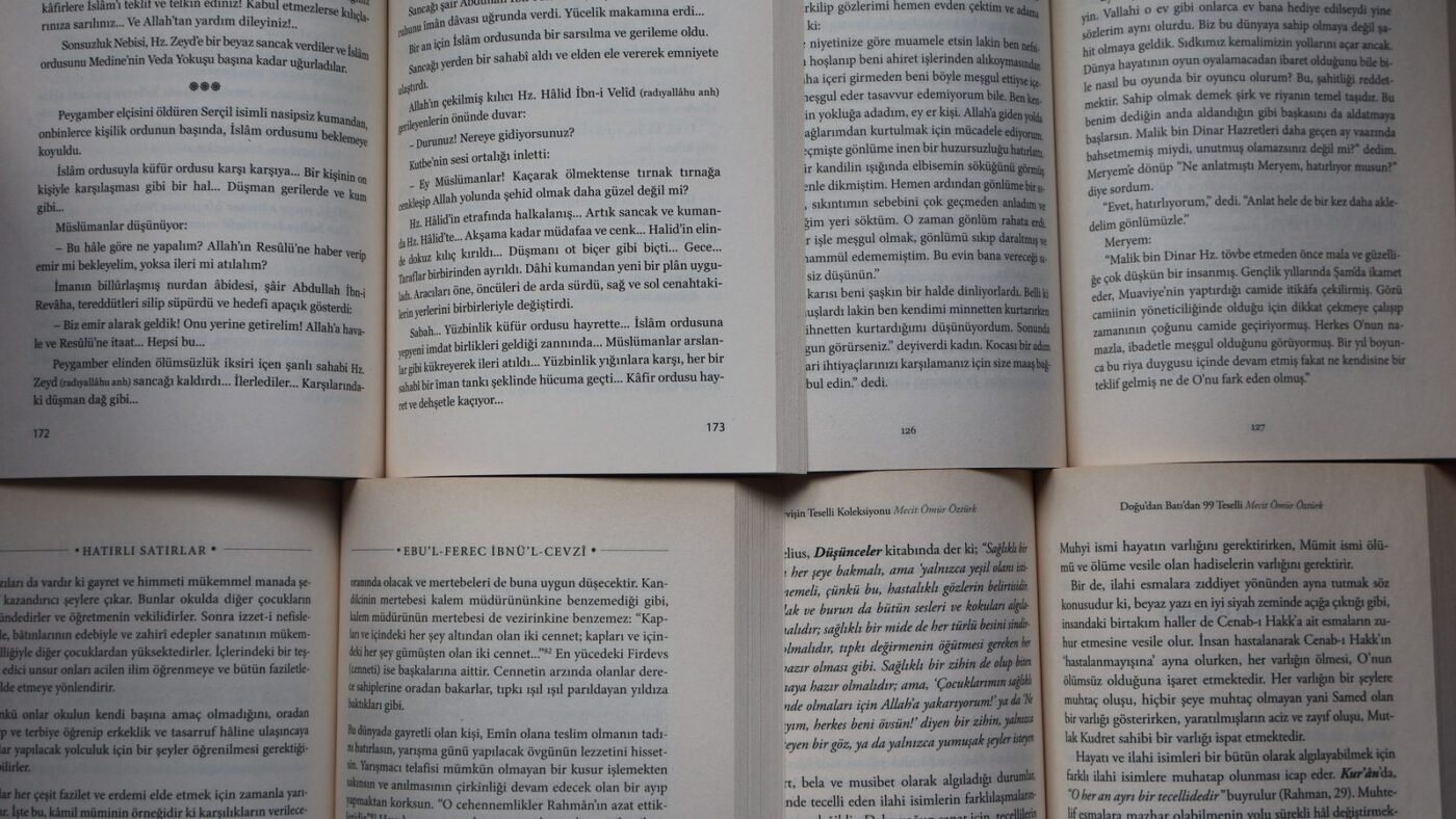 Pages of several open books laid side by side
