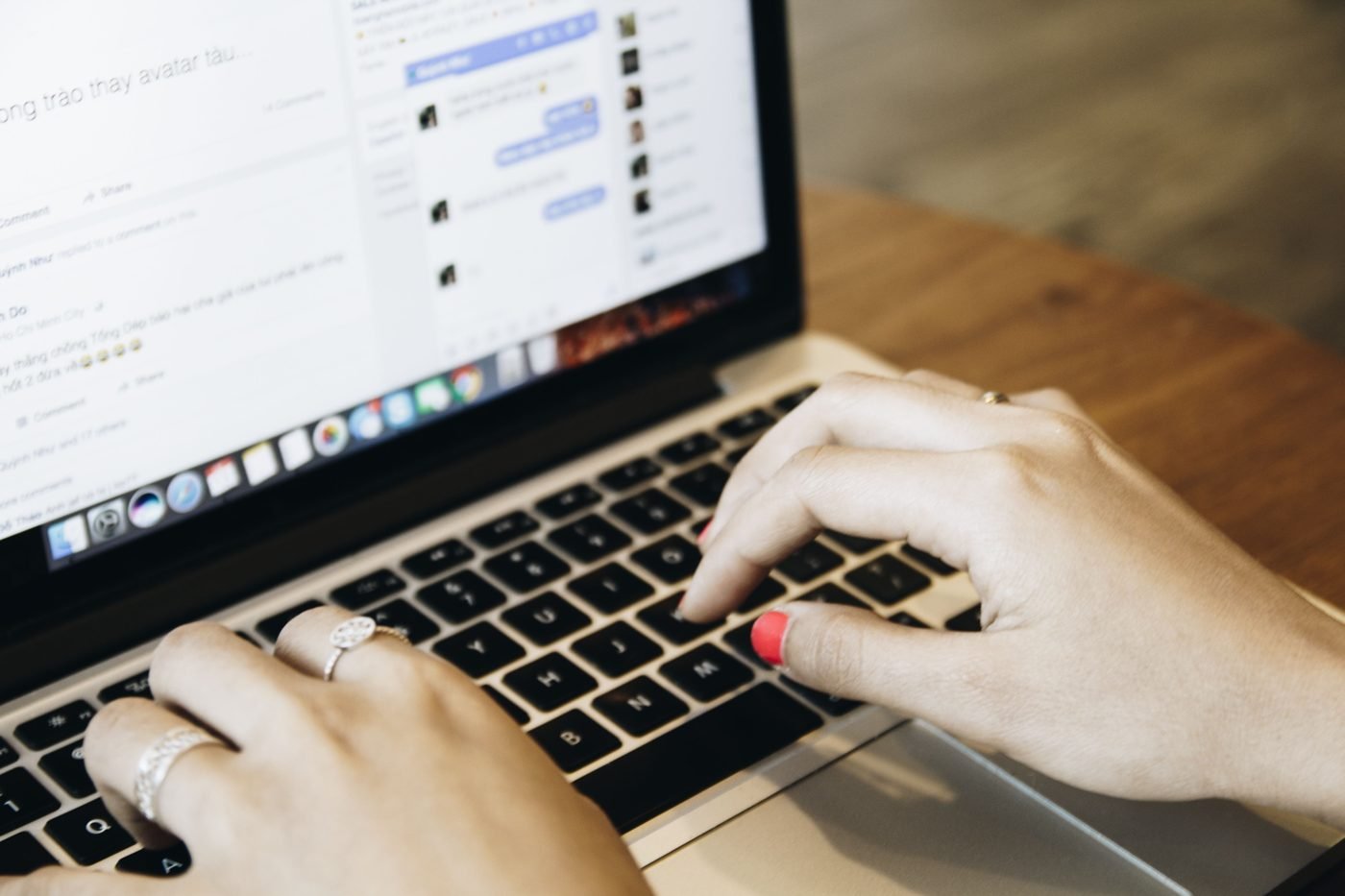 Hands typing on a laptop with a chat app open