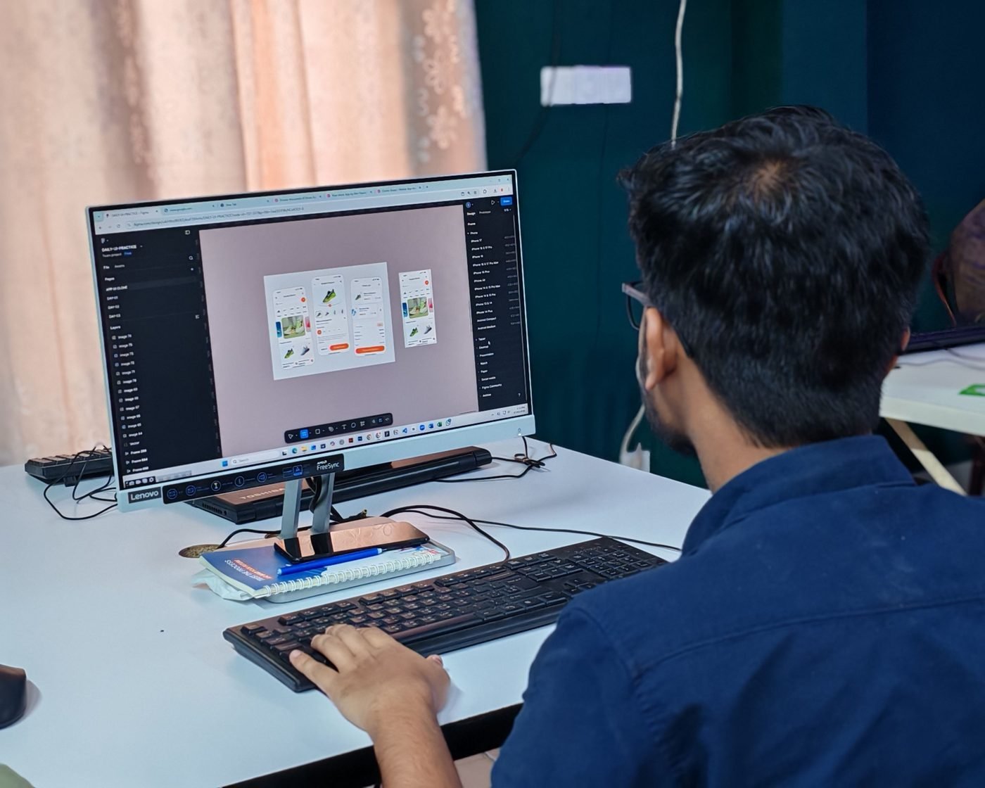 Designer creating user interfaces on a desktop computer