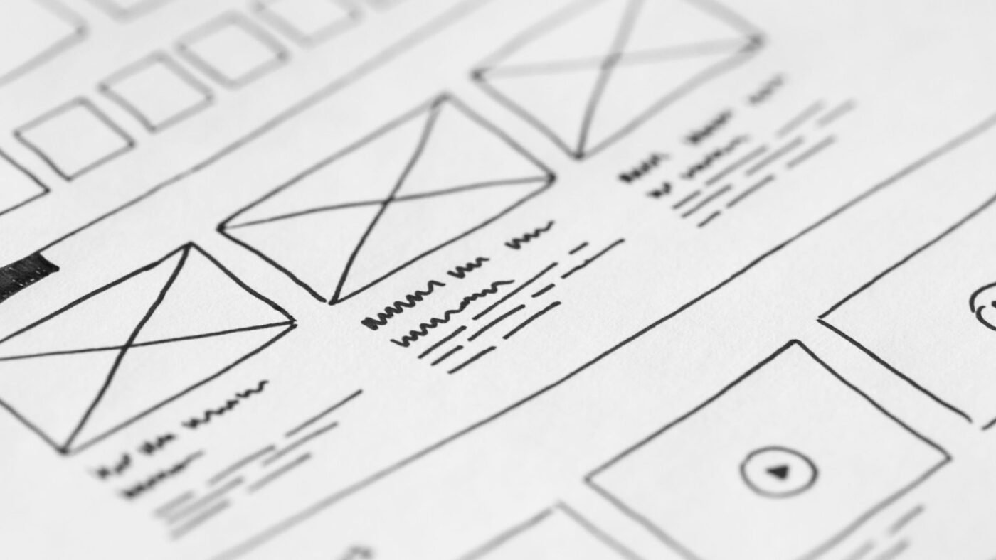 Close-up of a hand-drawn website wireframe sketched on paper