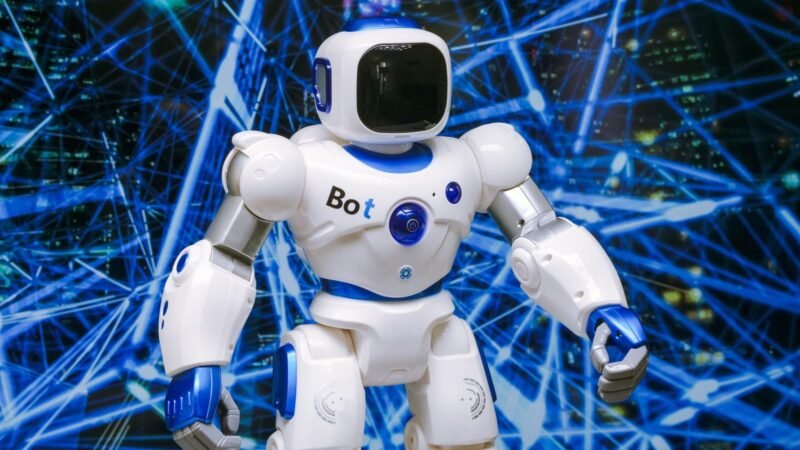 White humanoid robot with glowing blue accents against a digital network background